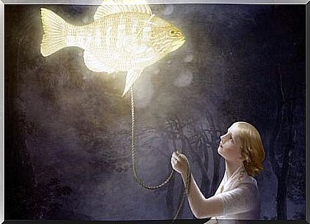 Woman holding a fish on a rope and giving that fish light