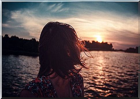 Woman looking over the sea that is without limits