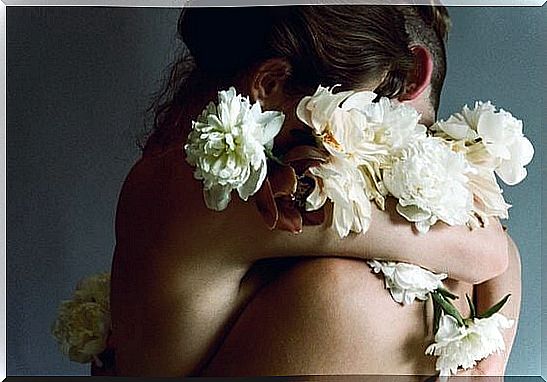 Two People Hugging And Being Surrounded By White Flowers Because Being Happy With What You Have Isn't So Hard