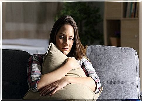 Sad woman holding pillow