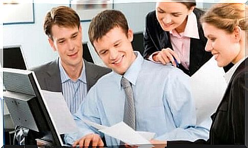 Group of people around a computer