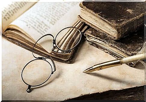 Old-fashioned reading glasses and books