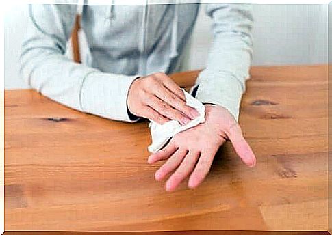 Person drying hands with a tissue