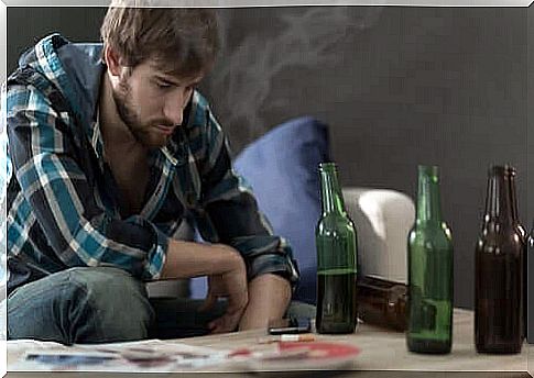 A man with many beer bottles on the table