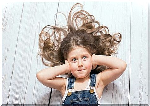 Girl holding her hands over her ears