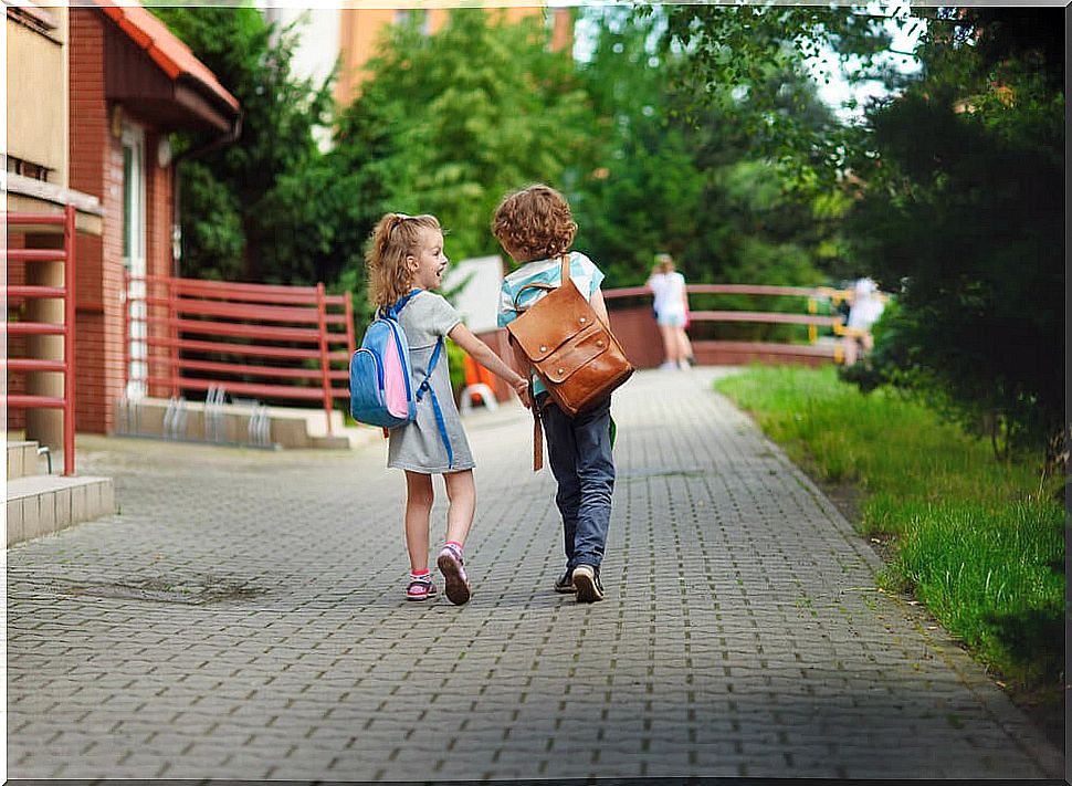 Two kids walking to school together