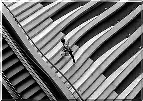 A man walks down a piano staircase