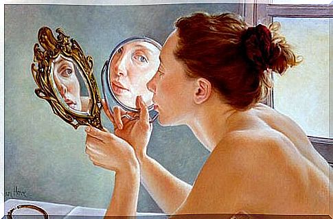 Woman looking at herself in the mirror