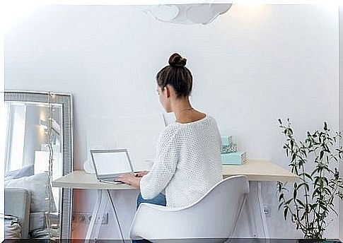 Woman sitting behind laptop